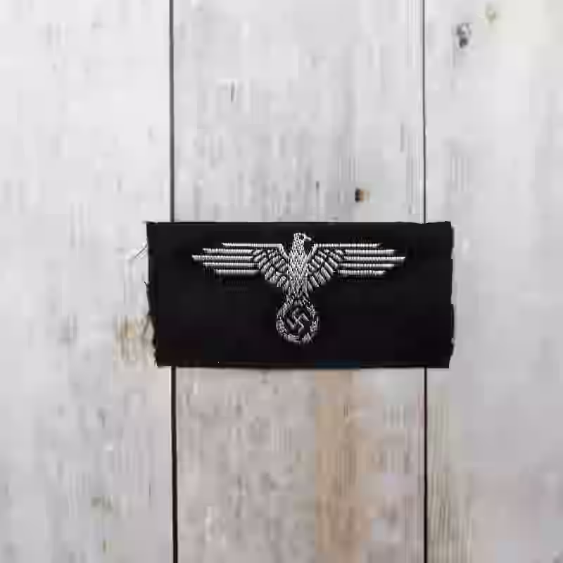 Waffen-SS Officers Cap Eagle - WWII-era Waffen-SS officers cap eagle with silk-woven silver eagle on black background for M40, M43, and M44 caps.