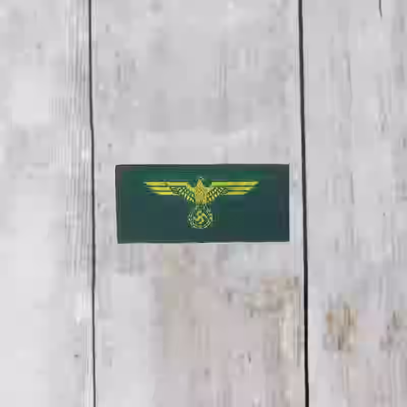 Coastal Artillery Enlisted Men's Silk Woven Cap Eagle - WWII-era Coastal Artillery enlisted men silk woven cap eagle with yellow eagle on green background.