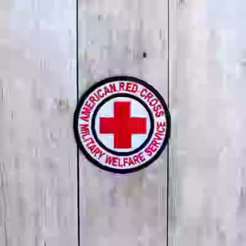 United States Women Army Corps Red Cross Badge - WWII-era US WAC Red Cross badge with red lettering and cross on white wool background.
