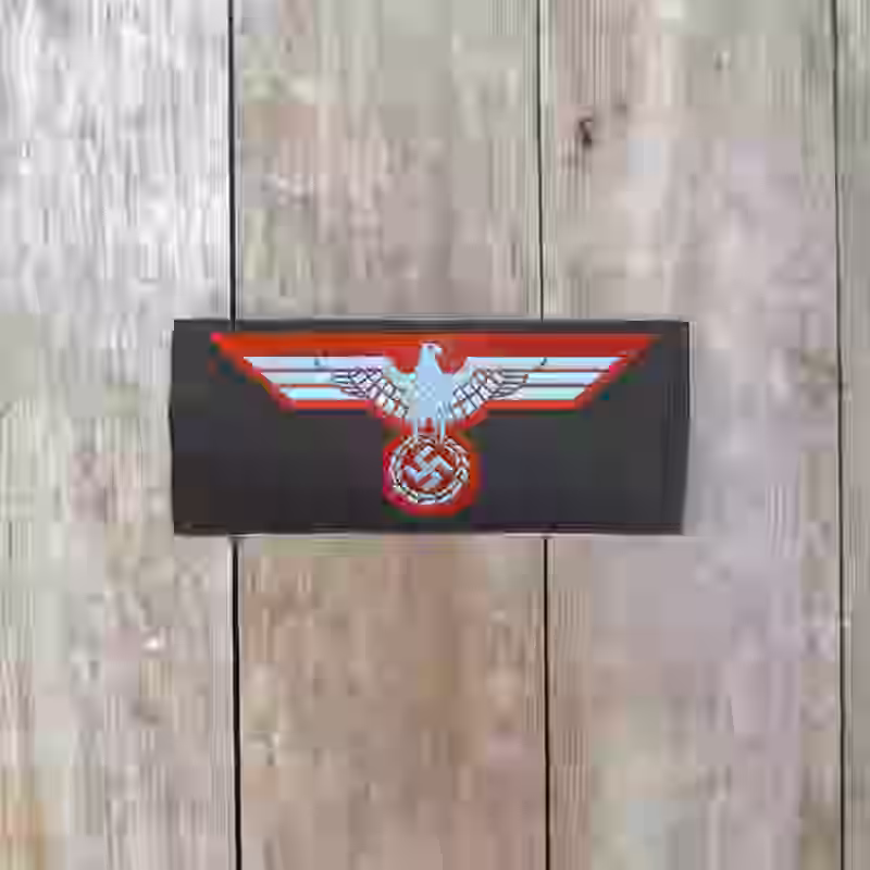 Afrika Korps Enlisted Men's Silk Woven Breast Eagle - WWII-era Afrika Korps enlisted man’s silk woven breast eagle, Be-Vo style, with light blue eagle on dark grey background.