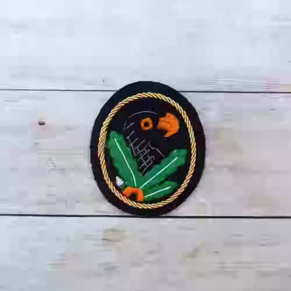 First Class Sniper Badge with Gold Trim - WWII-era first-class sniper badge with gold cord trim for 60 enemy kills.