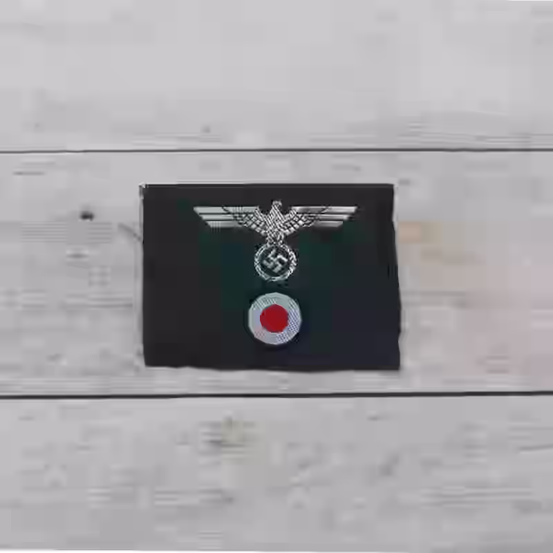 Wehrmacht M43 Officer's Trapezoid Cap Insignia - WWII-era Wehrmacht M43 officers’ trapezoid cap insignia with grey wool and dark green triangle.