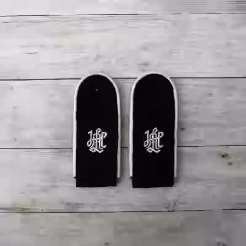 Leibstandarte SS Enlisted Men's Shoulder Boards - WWII-era Leibstandarte SS enlisted men’s shoulder boards with white piping on black wool for LSSAH uniforms.
