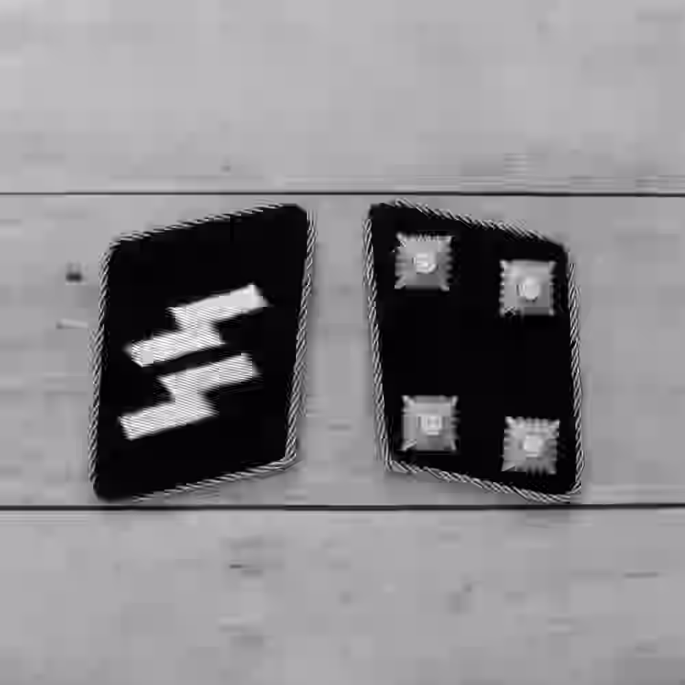 SS Sturmbannführer Collar Tabs - WWII-era SS Sturmbannführer collar tabs with four silver stars and silver piping on black wool.