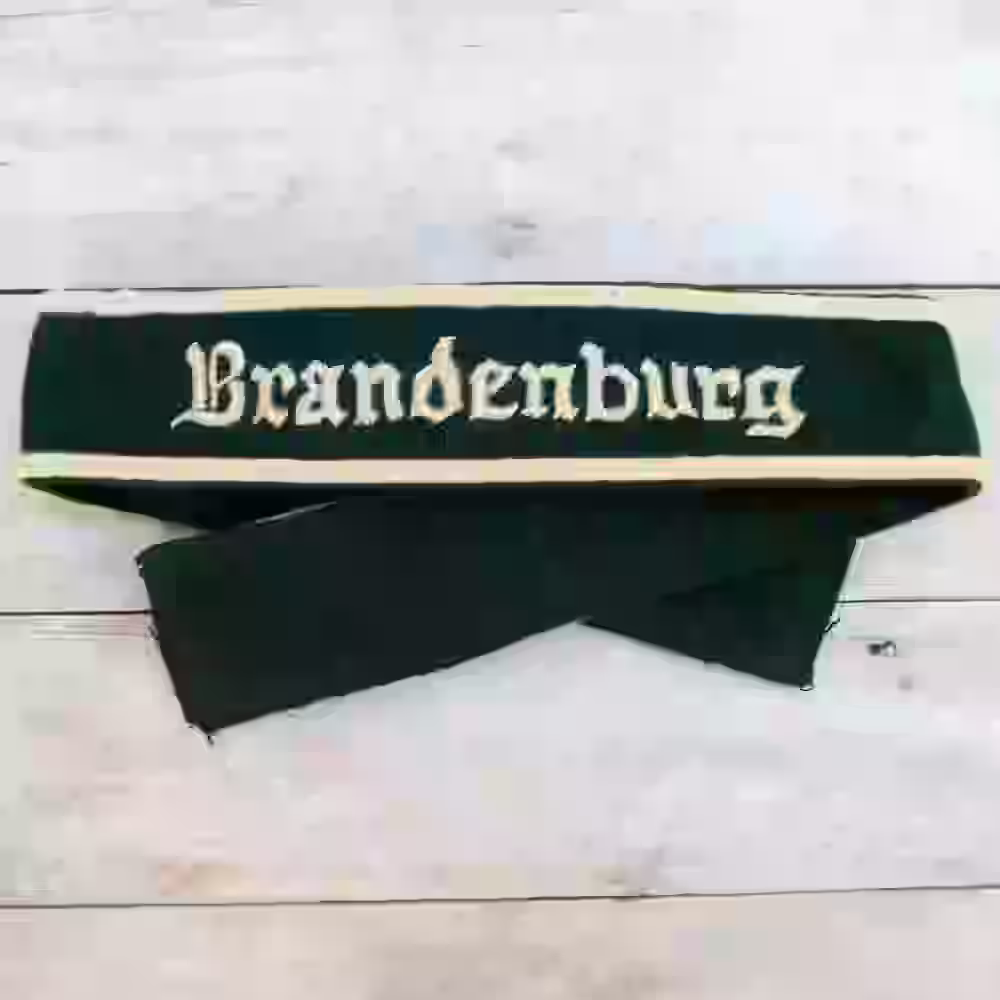 Brandenburg Division Hand-Embroidered Cuff Title - WWII-era Brandenburg Division cuff title with beige thread on dark green wool.