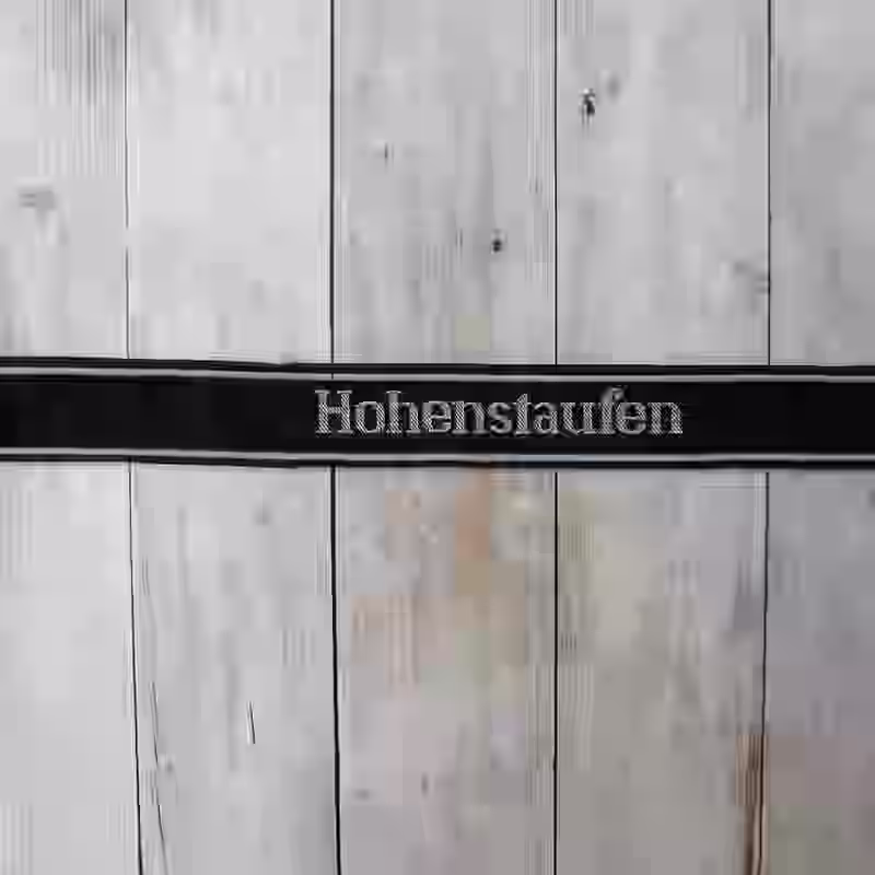Hohenstaufen EM Cuff Title - WWII-era Hohenstaufen enlisted men’s cuff title with grey thread on black silk base for 9th SS Panzer Division.