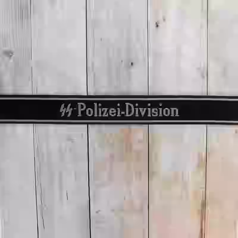 SS Polizei Division EM Cuff Title - WWII-era SS Polizei Division enlisted men’s cuff title with grey thread on black silk base for 4th SS Panzergrenadier Division.