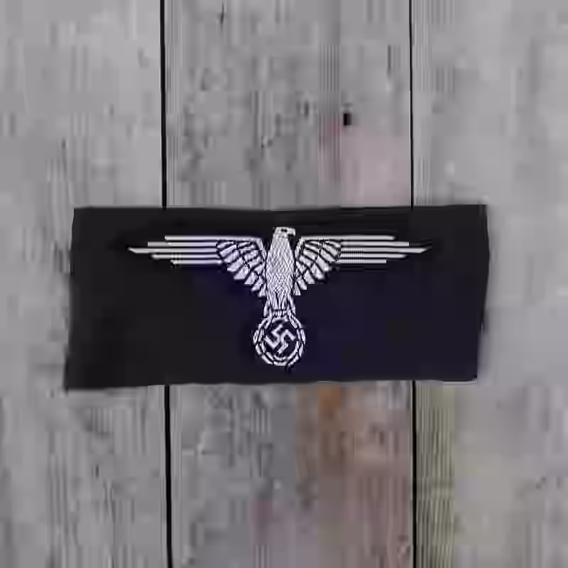 Waffen SS Enlisted Men’s Silk Woven Arm Eagle - WWII-era Waffen SS enlisted men’s silk woven arm eagle with white thread on black silk base for uniforms from 1934 onward.