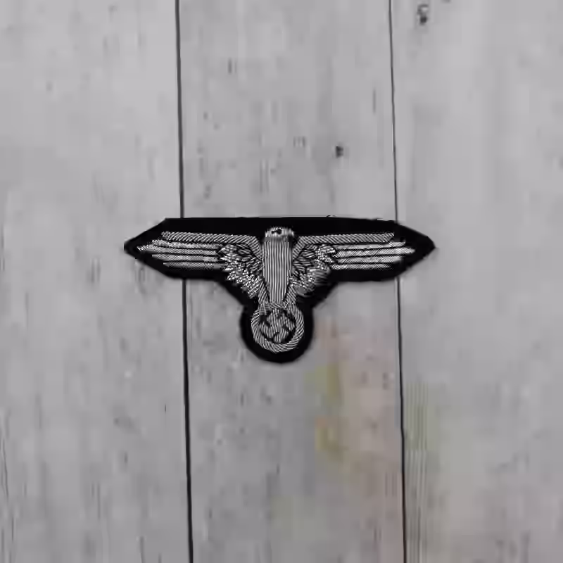 Waffen-SS Officer's Hand Embroidered Sleeve Eagle Waffen-SS Officer's Hand Embroidered Sleeve Eagle – Premium Replica, made of Hand-embroidered aluminum wire on black wool background