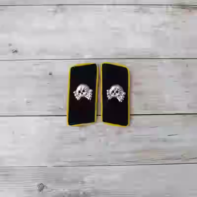 Panzer Communication and Signals Enlisted Men's Collar Tabs - WWII-era Panzer signals collar tabs with black wool, metal skulls, and yellow piping for enlisted communication units.