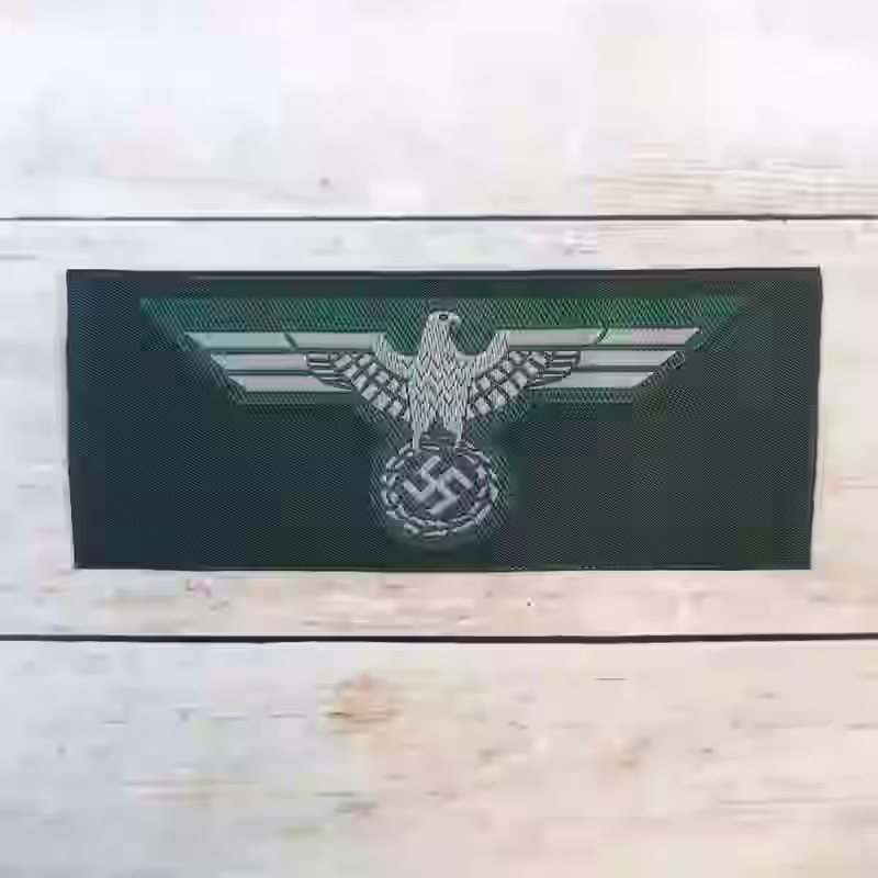 Wehrmacht Army Enlisted Men's Silk Woven Breast Eagle 1940 - WWII-era Wehrmacht enlisted men’s silk woven breast eagle from 1940 with grey eagle on dark green background.