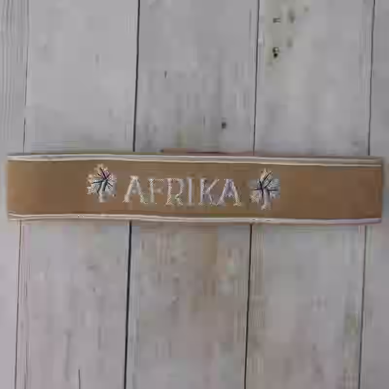 Afrika Korps Military Award Cuff Title - WWII-era Afrika Korps military award cuff title with tan wool and silver lettering.